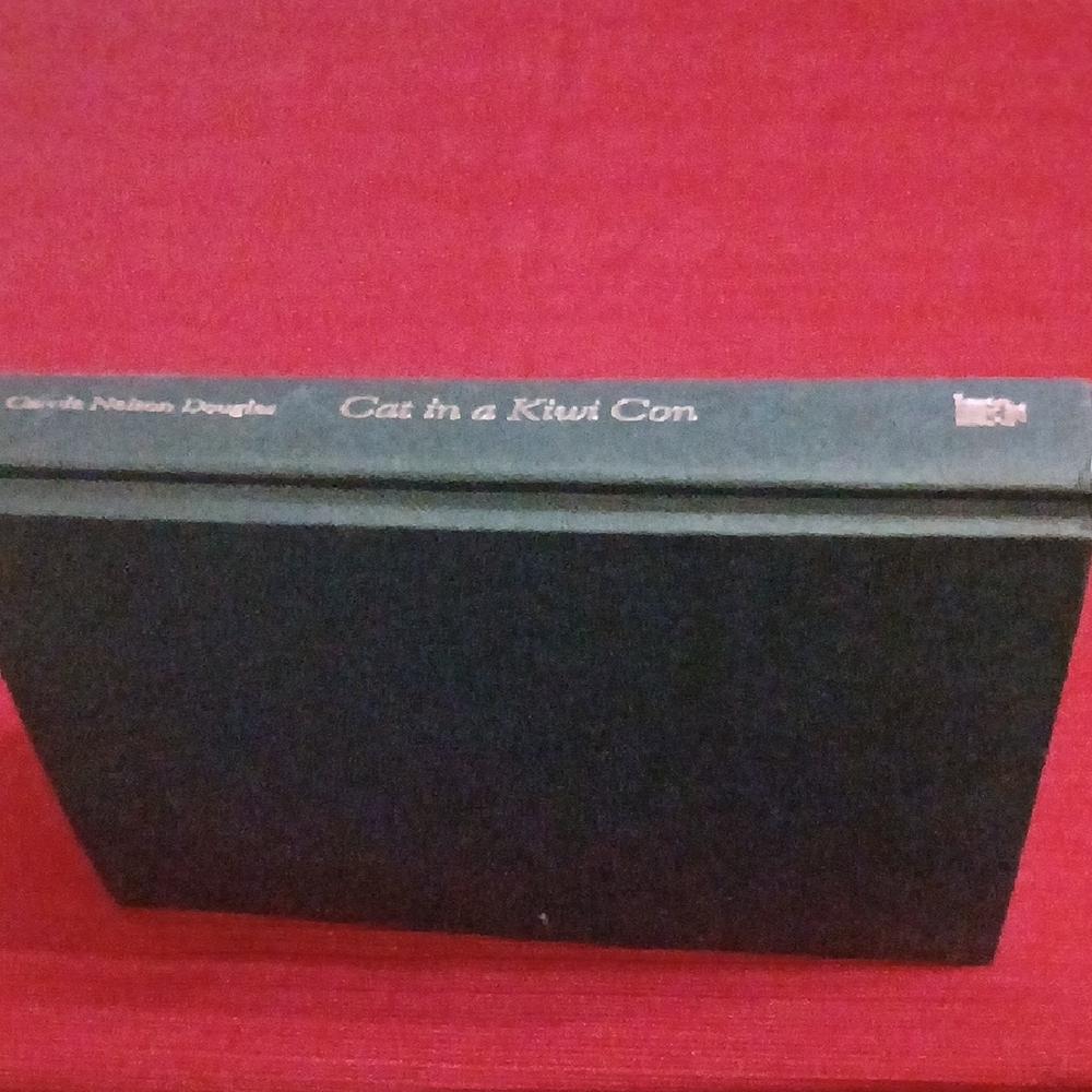 Cat in a Kiwi Con Hardcover Book - Black